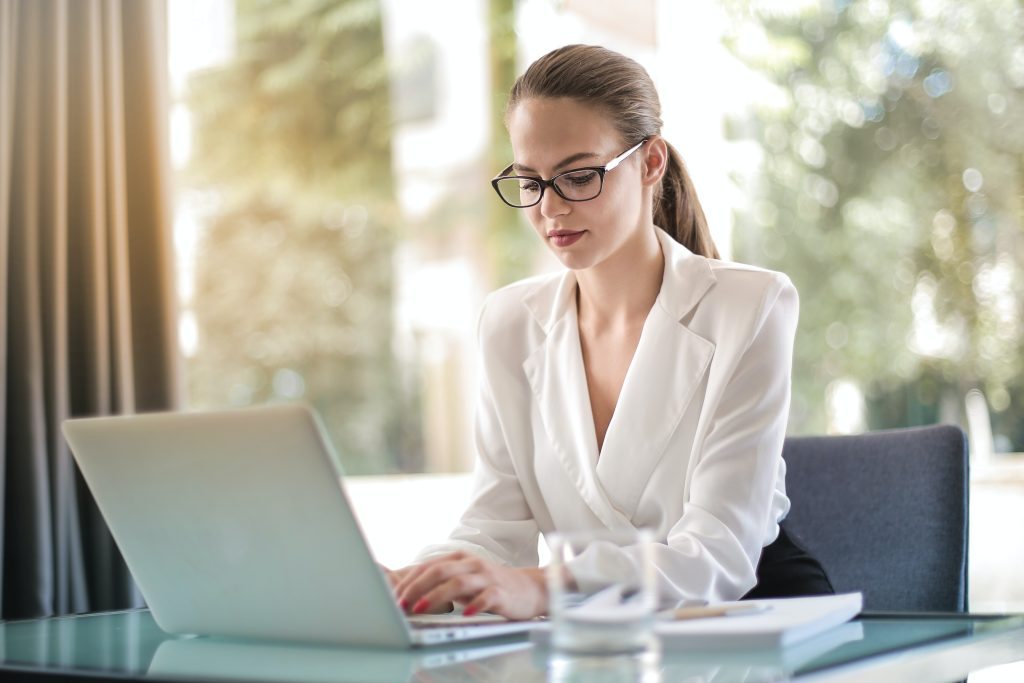 Business woman boosting her career by highlighting her accomplishments writing metrics and KPIs into her CV.